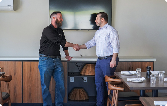 insight plus co-founder Tom Holtz shaking hands with man