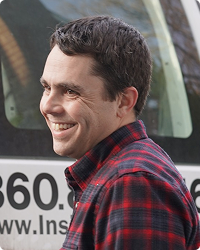 headshot of insight plus co-founder Ryan McKenna standing outside of insight plus van