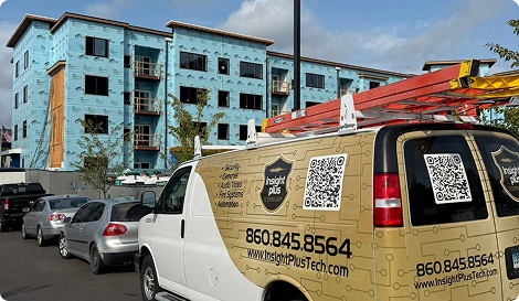 exterior of a van with insight plus technology branding, including brand colors, the logo, the company's website and phone number