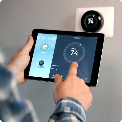 person holding tablet with a dashboard of the home's temperature settings